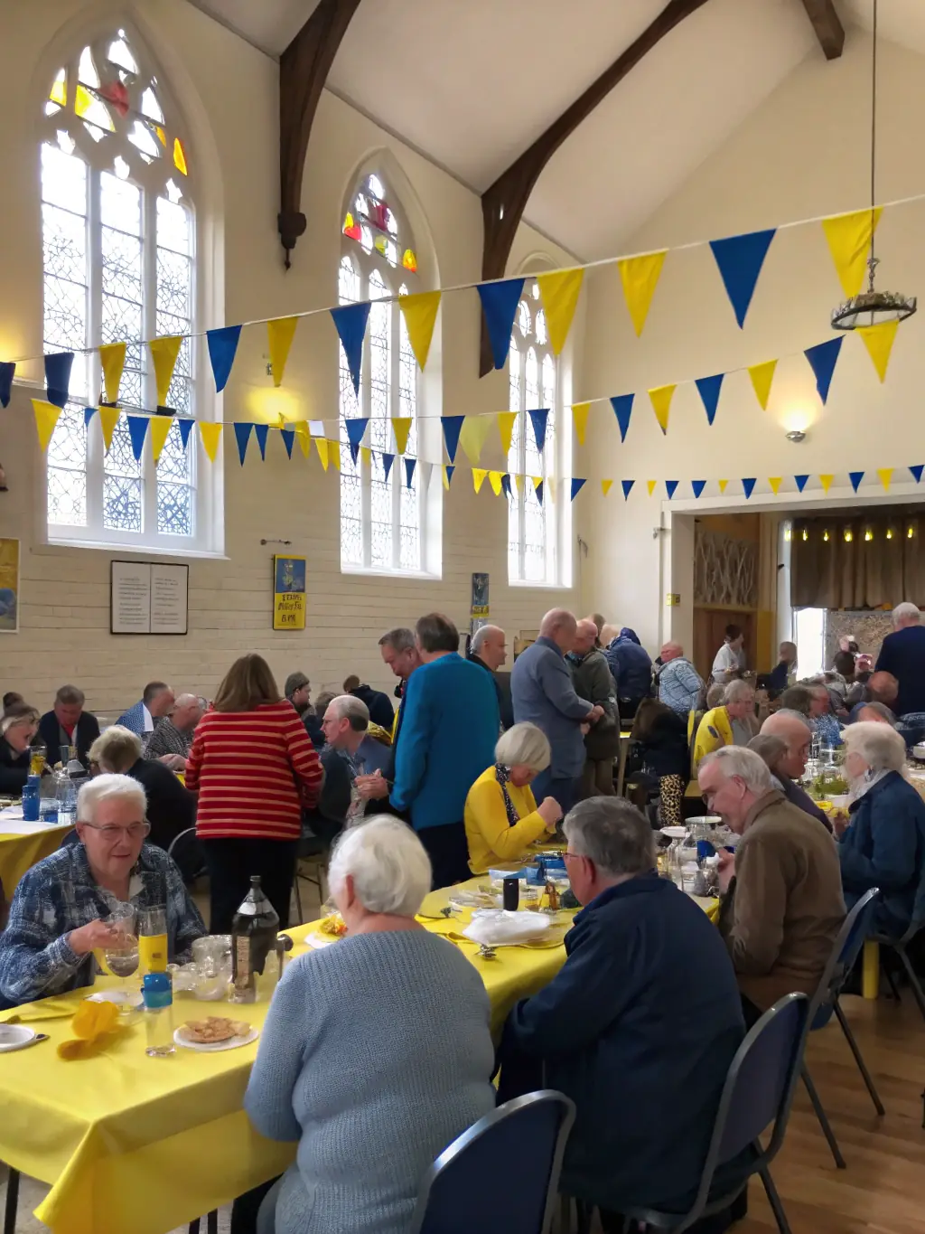 A photograph of a community event held at the Church of Saint-Georges-la-Pouge, showcasing people engaging with the space and its history.